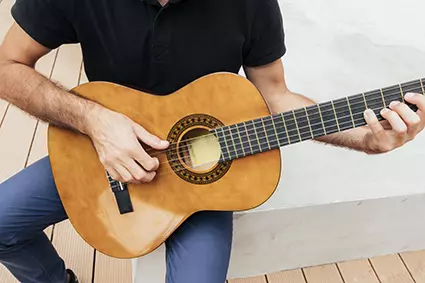 close-up-view-man-holding-guitar